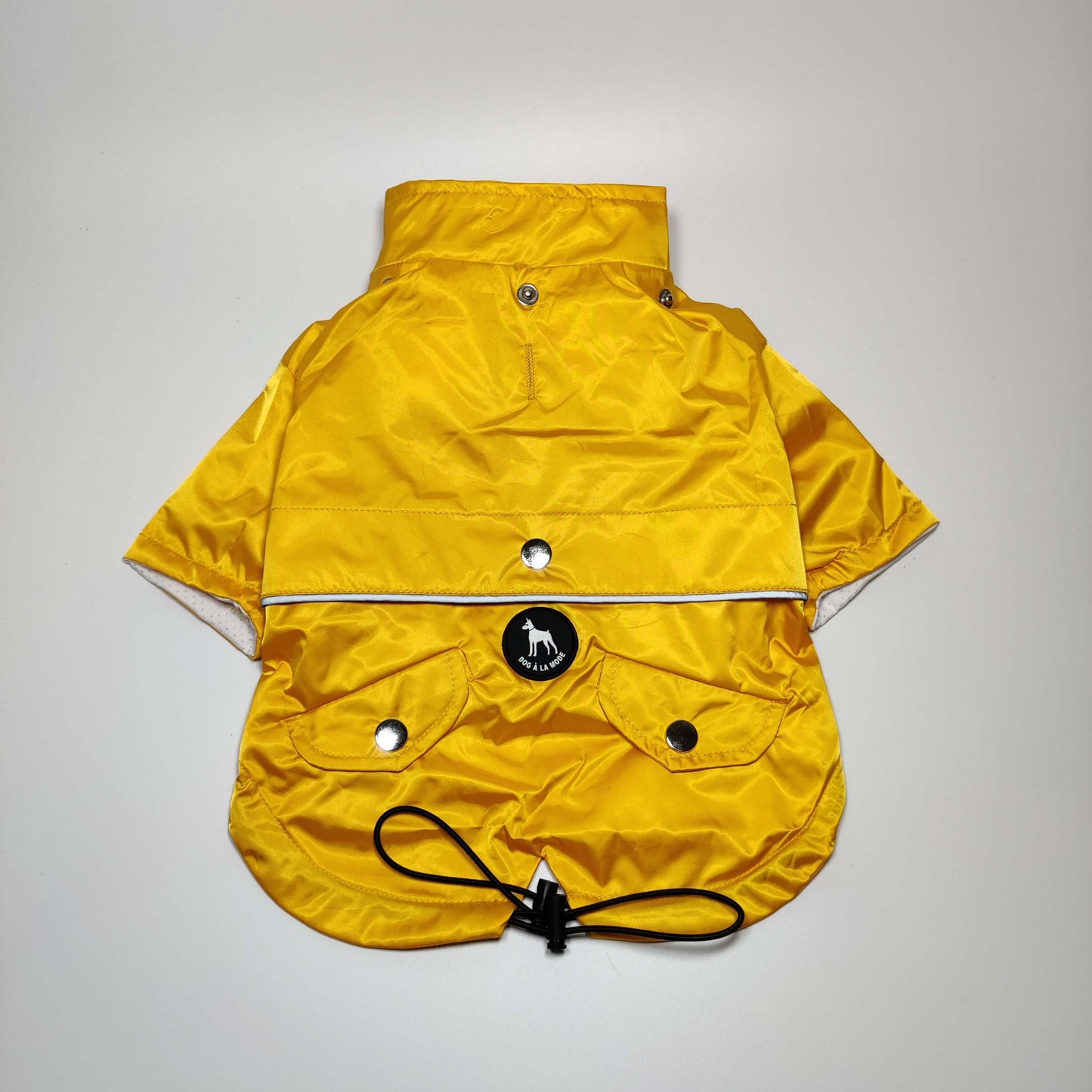 View of a dog running in the Yellow 'Buddy' Dog Raincoat showcasing mobility and comfort.